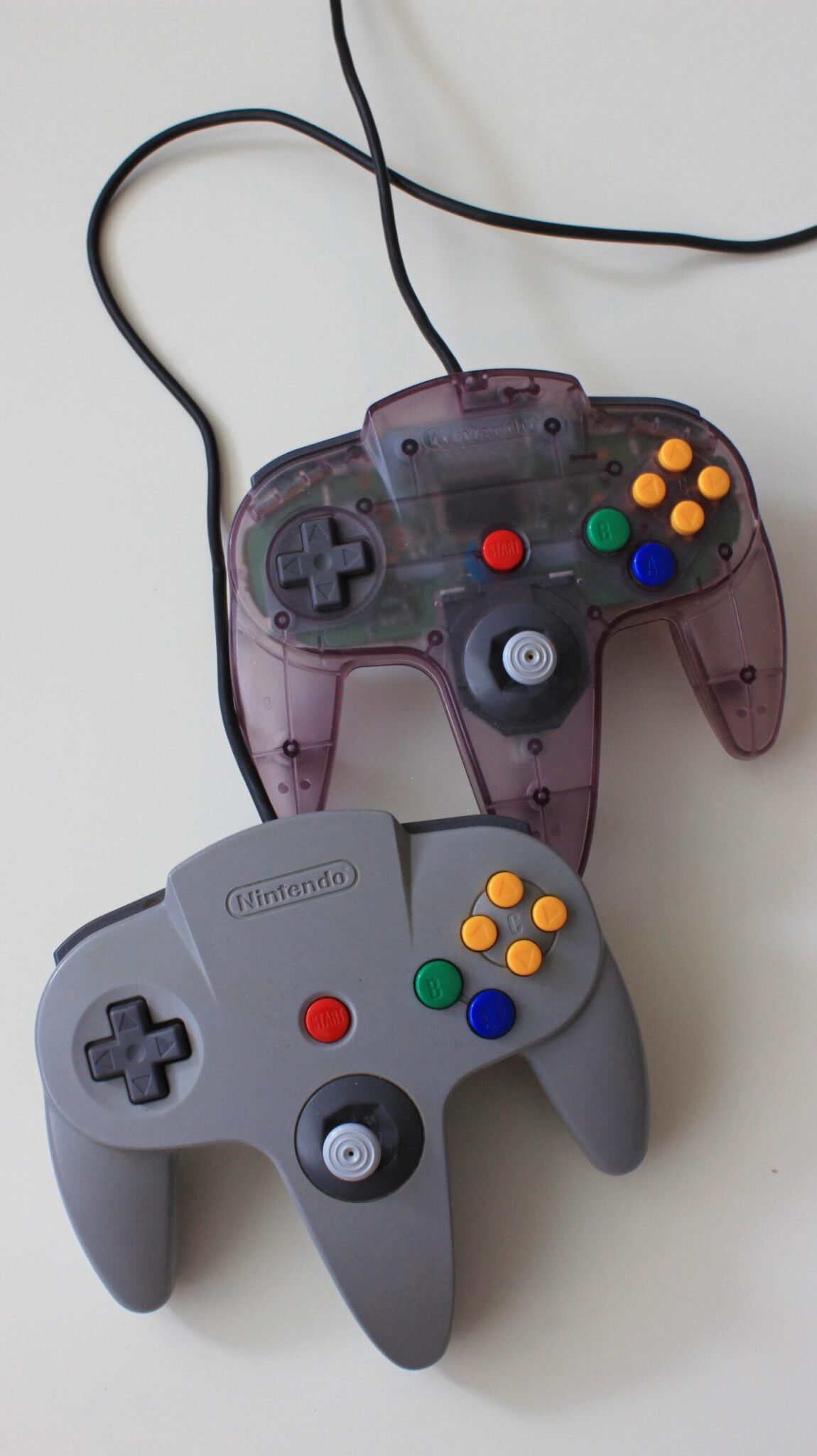 Grey and Purple Nintendo 64 Controllers